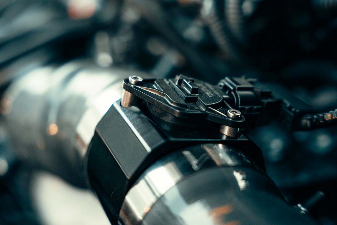 Close-up of cone air filter attached to a smooth intake tube