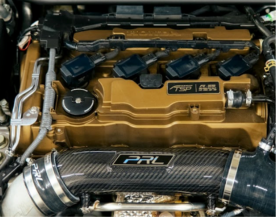 PRL Motorsports Turbocharger Inlet Pipe Kit installed on the engine of a vehicle.