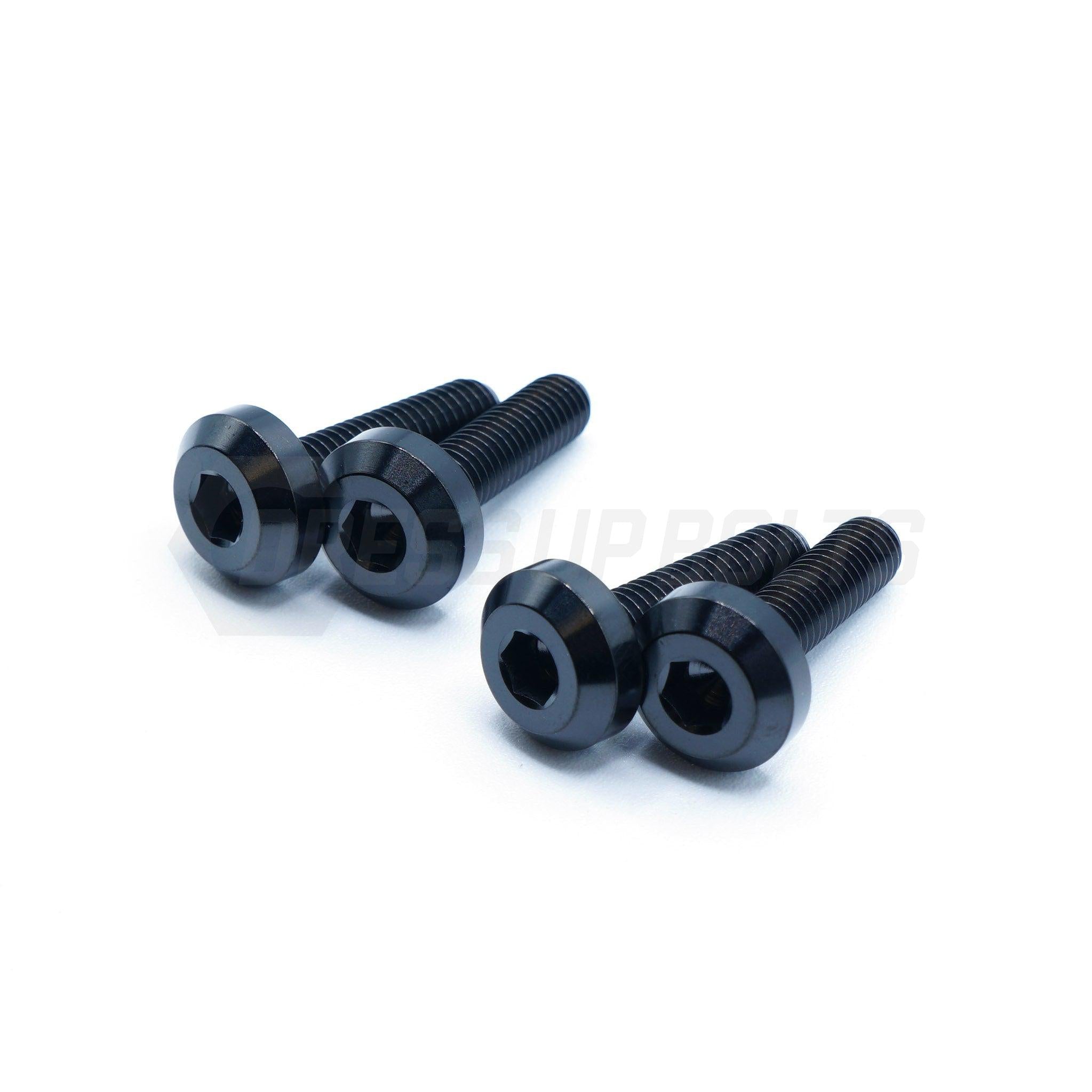 Four black screws on a white background