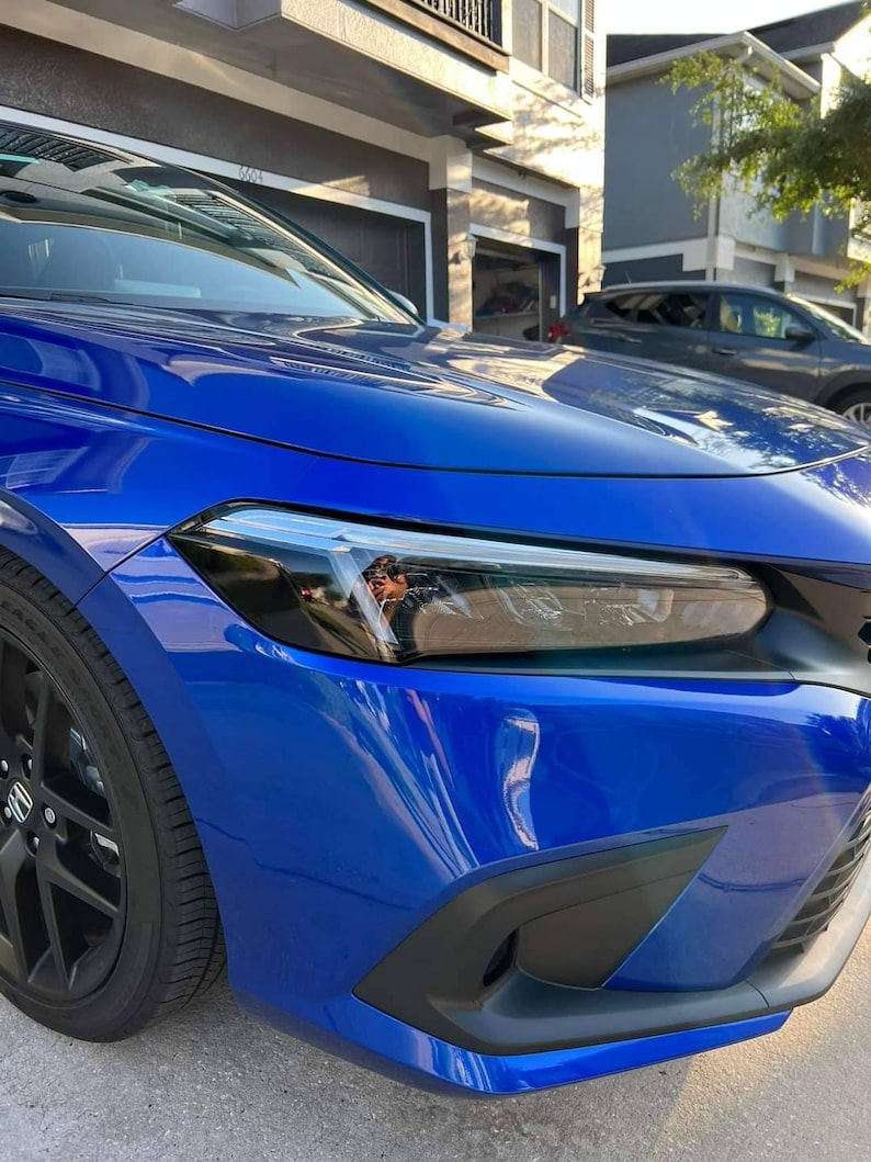 A close-up image of a blue Honda Civic side marker light with a tint overlay.