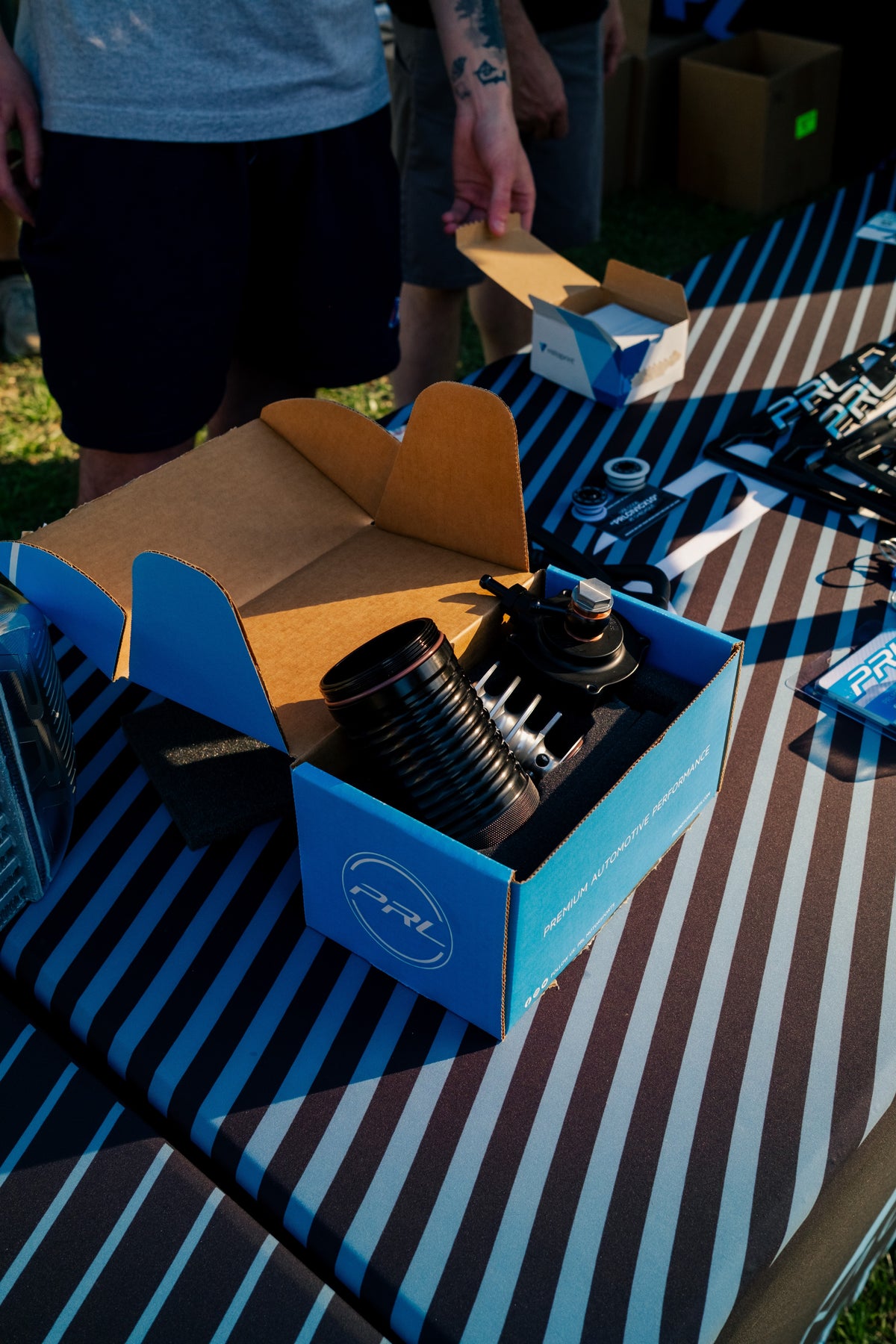A PRL Motorsports box open on a swap meet table with a turbocharger inside