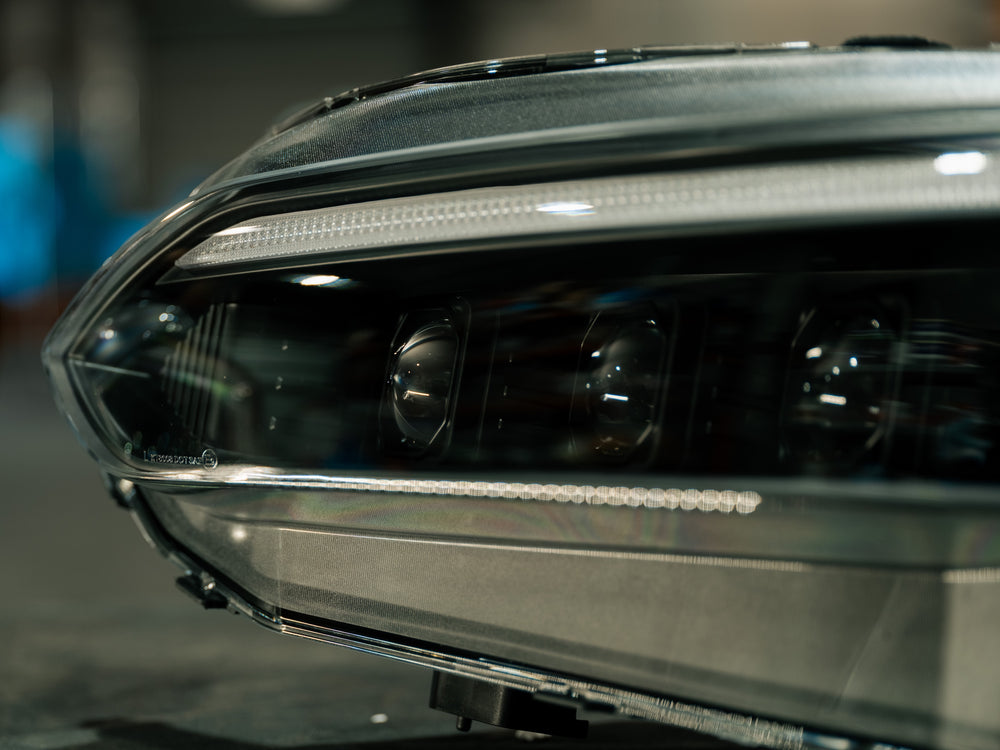 Close-up along the housing showing the LED projector elements and the textured DRL strip