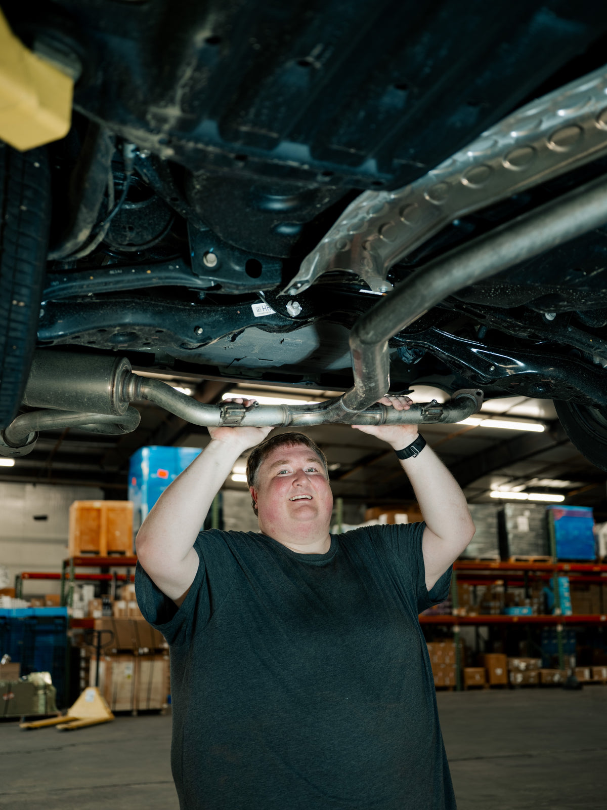Removing the factory exhaust from the TSP FE1 shop car during Hibiki development