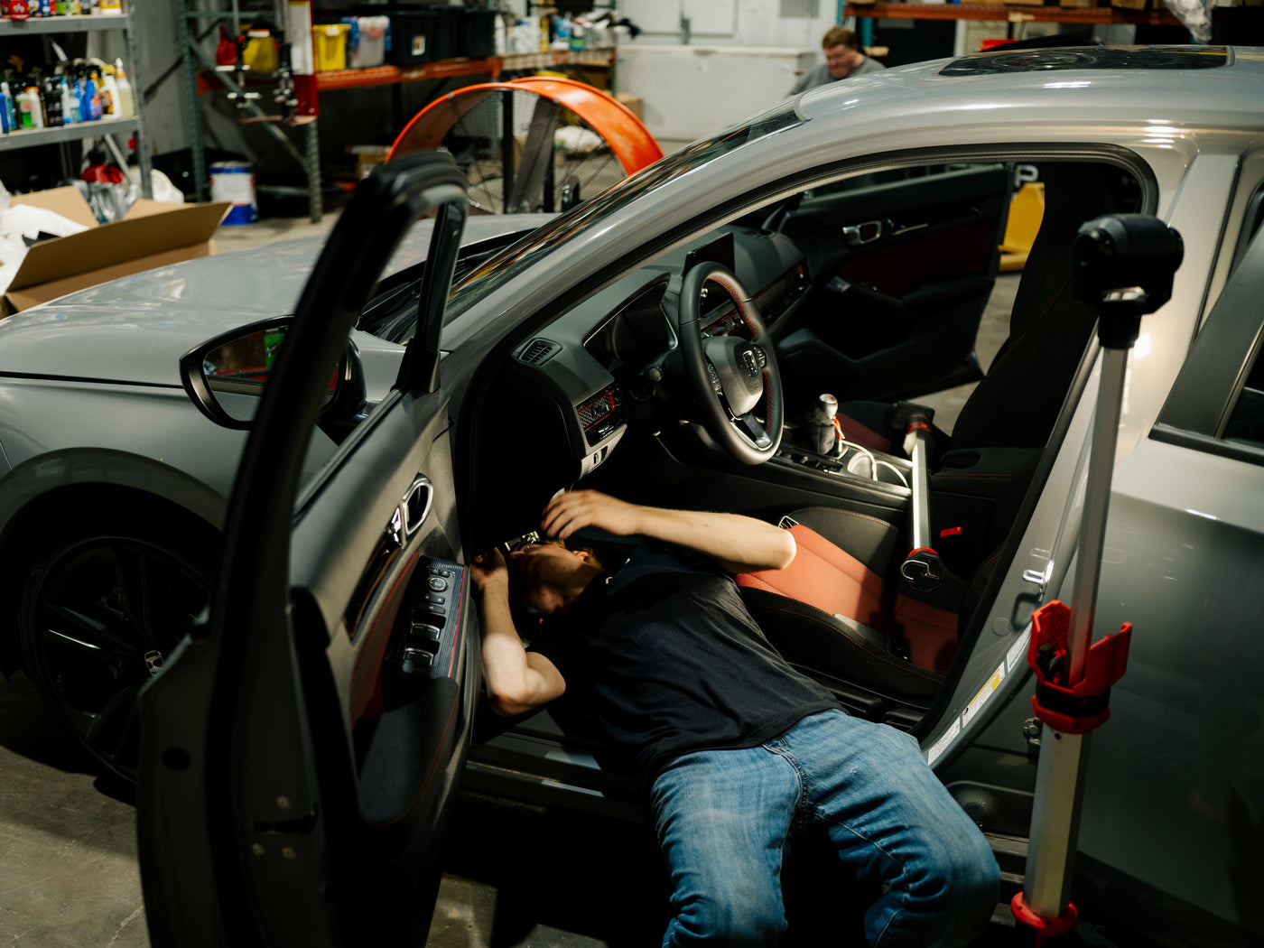 TSP technician routing the Hibiki valve controller wiring under the dash of a Honda Civic Si