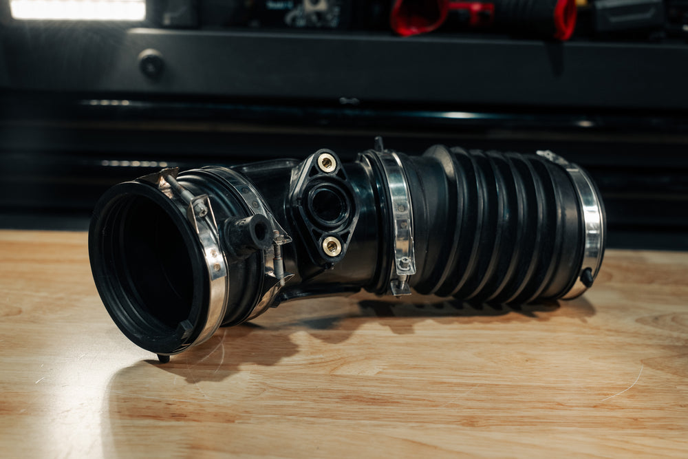 The factory Honda intake coupler assembly: rubber bellows, clamps and the plastic EVAP elbow