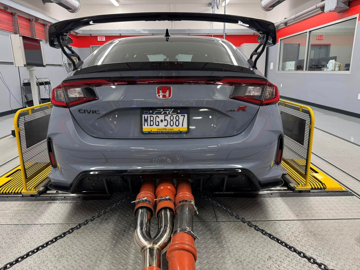 A Honda Civic Type R strapped to the emissions dyno at the SEMA Garage with sampling lines in the exhaust
